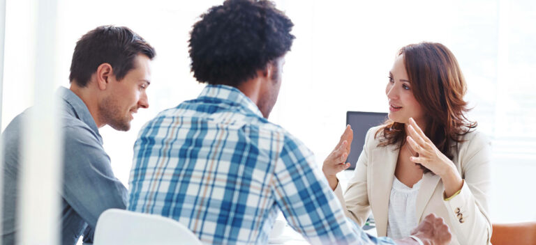 Two Men Speaking With A Banker When They Apply For A Business Loan