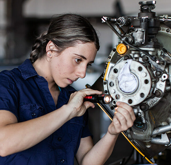 A Young Apprentice Working On A Machine