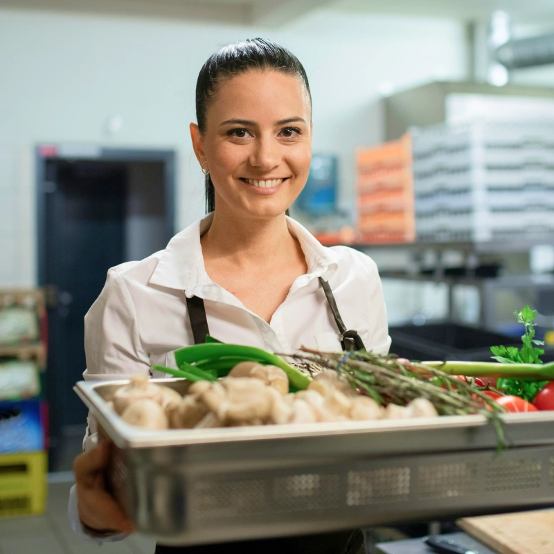 Sydney restaurant owner carrying fresh produce in commercial kitchen - Moula business loan customer